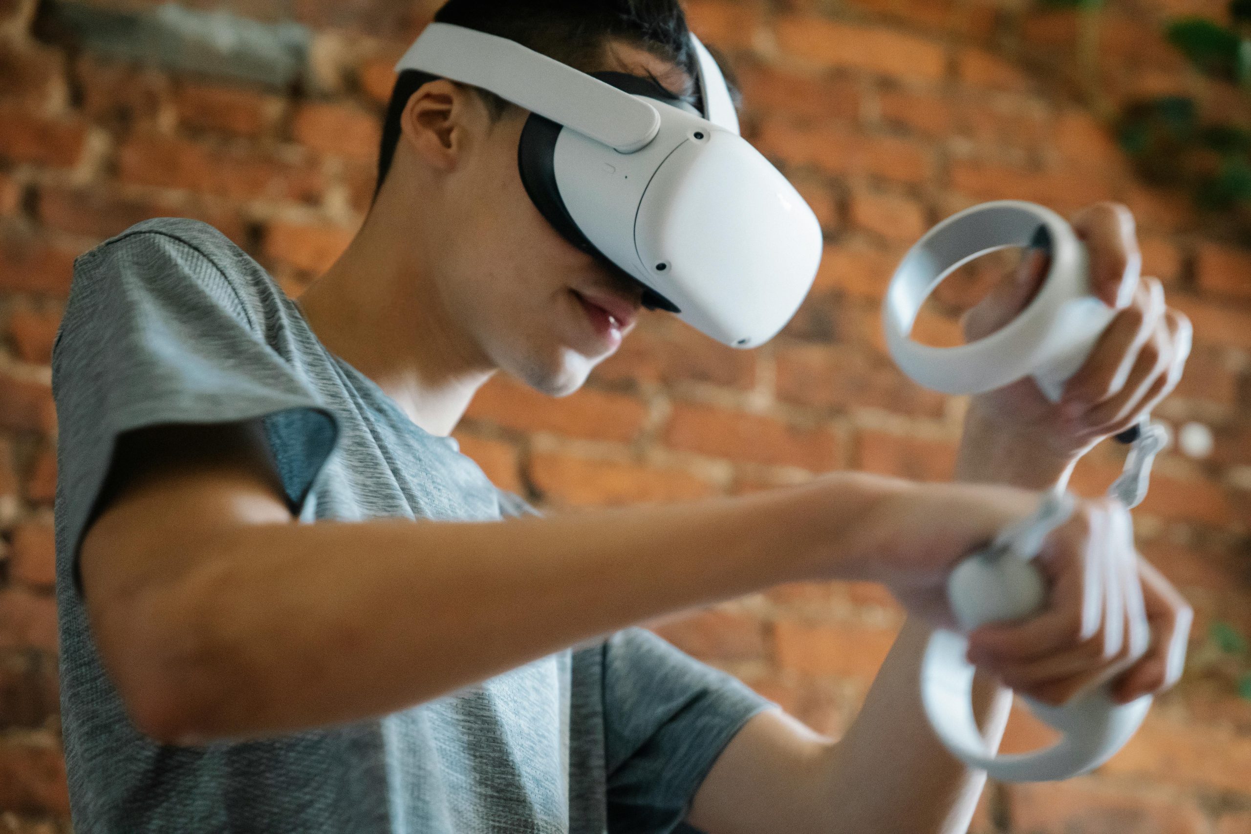 A person wearing a VR headset and playing a VR game.